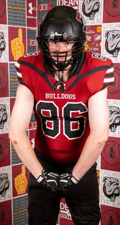 Eli Kestenbaum wearing a red football uniform with number 86 and a helmet; original watermarks remain visible across the image.